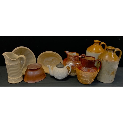 190 - Brampton salt glaze moulded jug,18cm high, another, stoneware flagons, a set of three blancmange mou... 