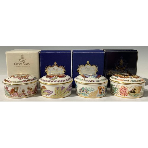 5262 - A set of four Royal Crown Derby Butterflies of The World circular trinket pots and covers, comprisin... 