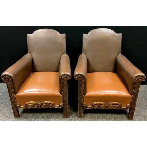 193 - A pair of Arts and Crafts style carved oak and leatherette armchairs, 88.5cm high x 72cm wide x 70cm... 