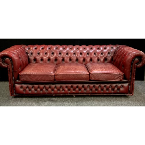 201 - An Oxblood red leather chesterfield three seater sofa, 67cm high, 200cm wide, 90cm deep, seat height... 