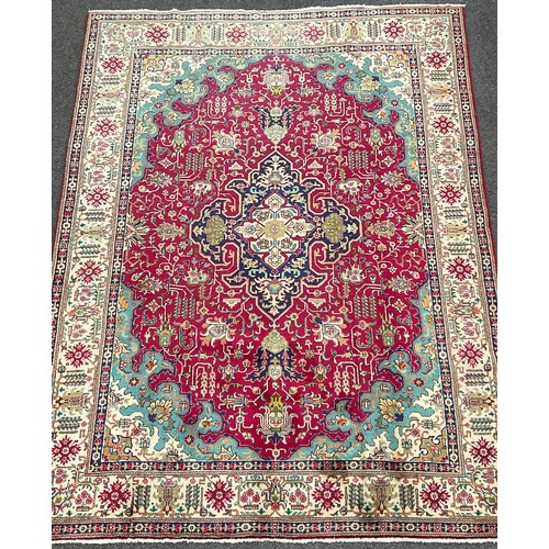 205 - A North West Persian Heriz Carpet, hand-knotted in tones of red, deep blue, turquoise, and cream, 34... 