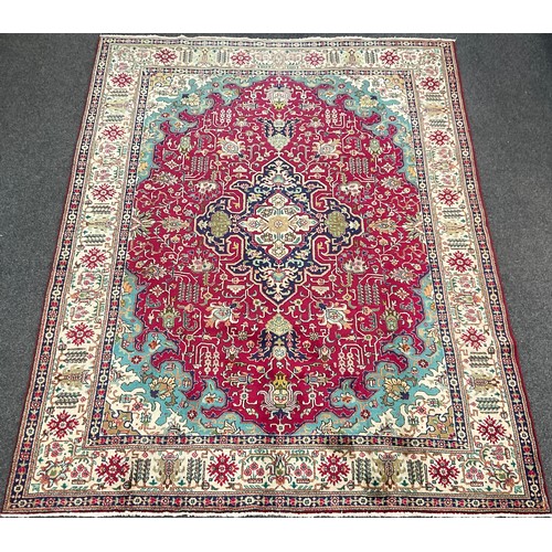 205 - A North West Persian Heriz Carpet, hand-knotted in tones of red, deep blue, turquoise, and cream, 34... 