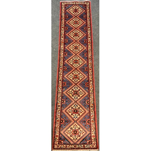 214 - A North-west Persian Rudbar runner carpet, hand-knotted with central row of nine diamond-form medall... 