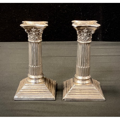 290 - A pair of Edwardian silver Corinthian column candlesticks, weighted base, Sheffield 1908, 11.5cm hig... 