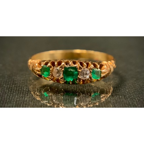 310 - A diamond and emerald ring, set with three emerald and two diamonds in alternating crest, unmarked y... 