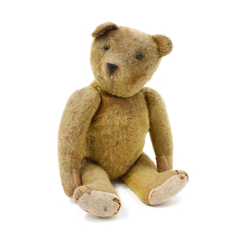 7207 - An early 20th century golden mohair jointed teddy bear, black boot button eyes, pronounced snout wit... 