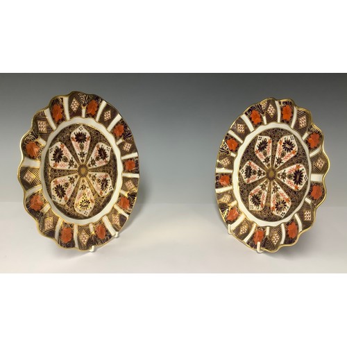 3030 - A pair of Royal Crown derby Imari palette 1128 pattern shaped circular plates, 21cm diameter, printe... 