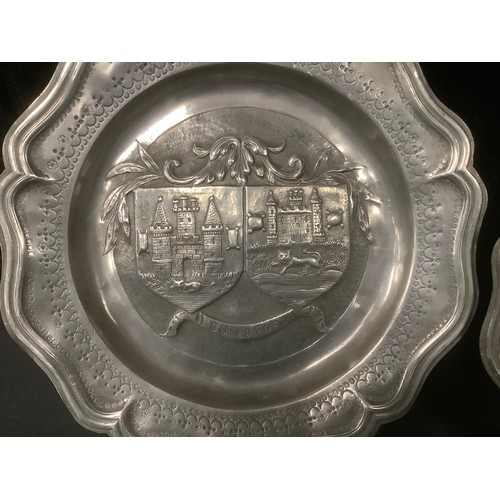 3054 - A pewter heavy gauge shaped circular plate, the central field embossed with the Guildford coat of ar... 