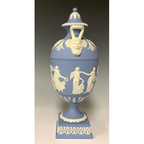 3171 - A Wedgwood Jasperware two-handled pedestal urn and cover, the handles with Bacchic mask terminals, t... 