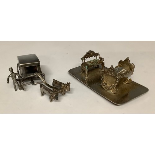 3207 - Boxes & Objects - an ornate steel Art Nouveau miniature sofa and crib; a miniature ox-drawn sled and... 