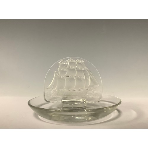 3246 - A Lalique Tall Ships pattern ring tray, applied with a frosted glass galleon motif, 10cm diameter, e... 