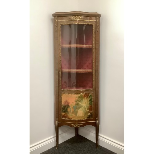 3310 - A Louis XV style gilt metal mounted mahogany serpentine corner vitrine, three-quarter glazed door ap... 