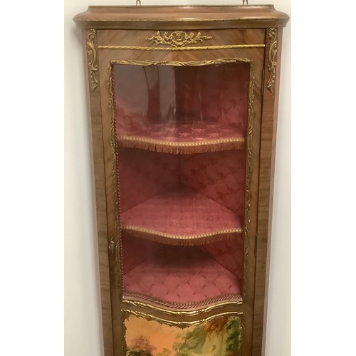 3310 - A Louis XV style gilt metal mounted mahogany serpentine corner vitrine, three-quarter glazed door ap... 