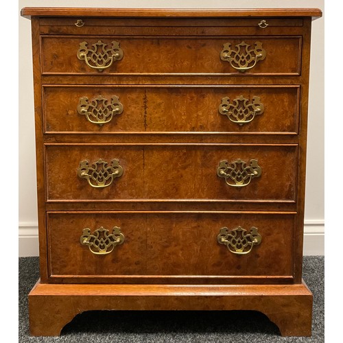 3311 - A George I style amboyna bachelors chest, quarter veneered top outline with boxwood stringing, the m... 