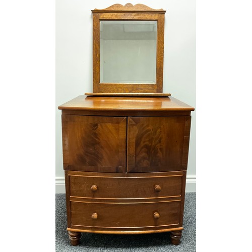 3312 - A Victorian mahogany bow front night chest, the top lifting above a pair of flame veneered drawers a... 