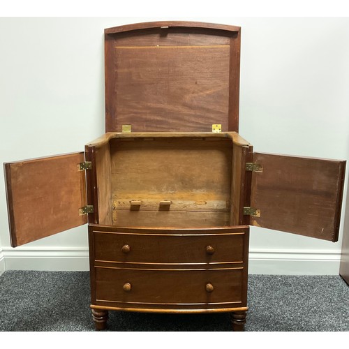 3312 - A Victorian mahogany bow front night chest, the top lifting above a pair of flame veneered drawers a... 