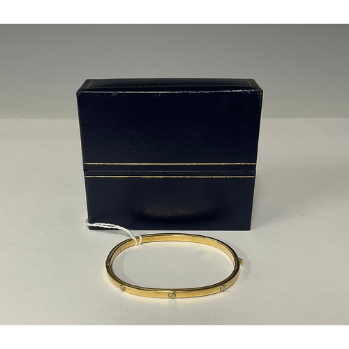 3360 - A 9ct gold hinged bangle, cast with six rivets, 6cm interior, marked 375, 6.5g, boxed