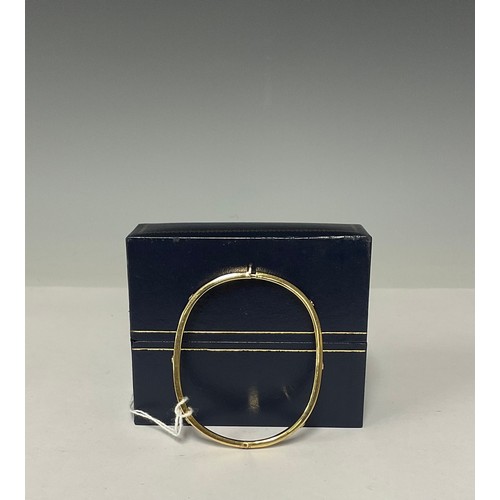 3360 - A 9ct gold hinged bangle, cast with six rivets, 6cm interior, marked 375, 6.5g, boxed