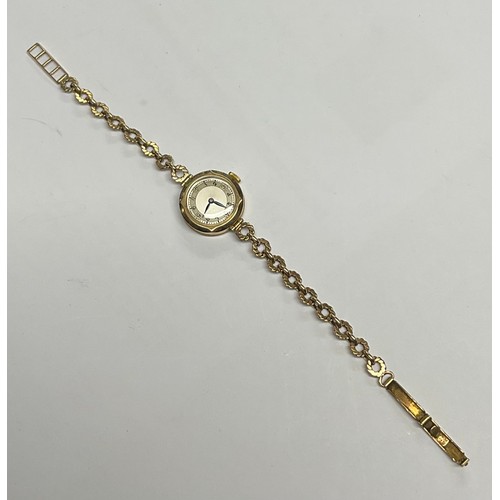 3364 - A lady's 9ct gold watch, silvered dial, Arabic numerals, the case marked 375, integral 9ct gold fanc... 