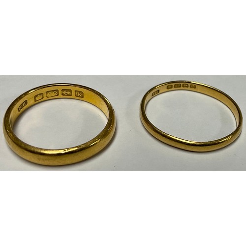 3386 - Gold Rings - a 22ct gold wedding band; another (2)