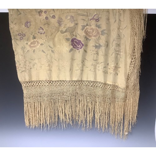 3315A - An early 20th century silk piano shawl, machine stitched with fanciful birds and butterflies perched... 