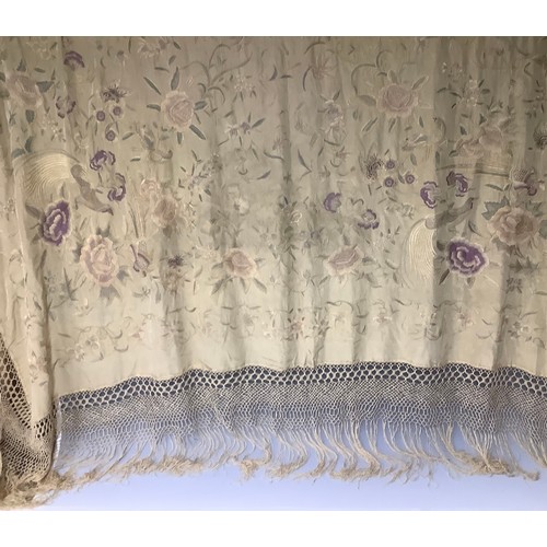 3315A - An early 20th century silk piano shawl, machine stitched with fanciful birds and butterflies perched... 