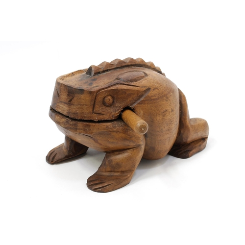 259 - A carved hardwood frog rasp percussion instrument, 26cm long