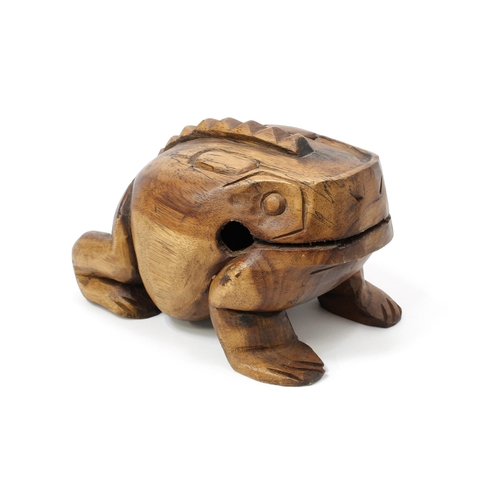 259 - A carved hardwood frog rasp percussion instrument, 26cm long