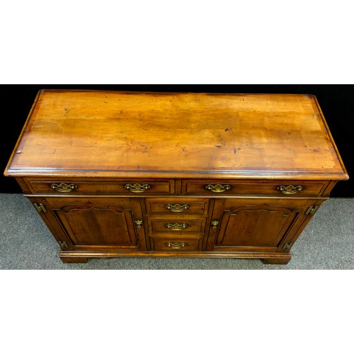 41 - A walnut sideboard by Simon Simpson, of Norwich, yew-wood cross-banded top, two long drawers to frie... 