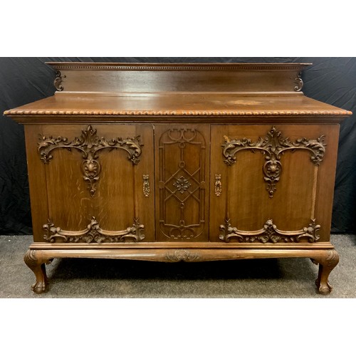 60 - A Gothic style oak Buffet sideboard, quarter-galleried over-sailing top with gadrooned edge, over a ... 