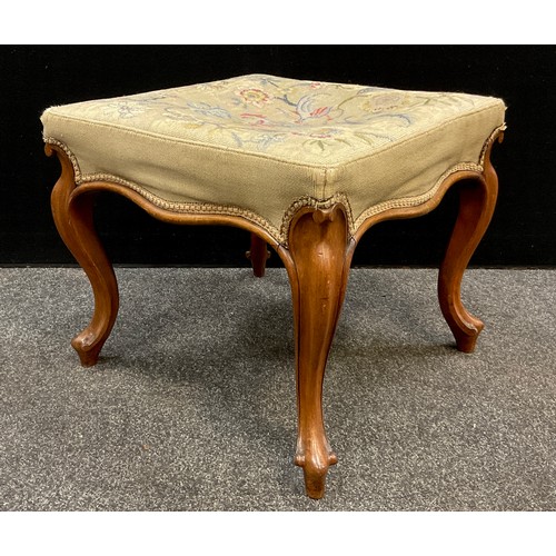 67 - An early Victorian walnut stool, needlework upholstered seat, serpentine shaped sides, serpentine le... 