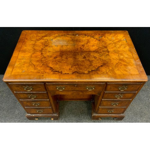 82 - A George II style walnut and Burr walnut knee-hole desk, single drawer to frieze, above a ‘secret’ d... 