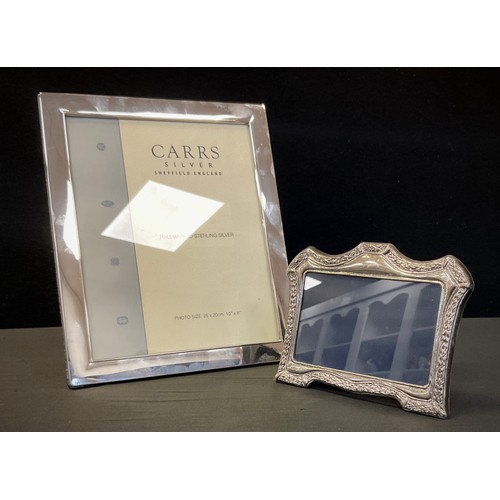 304 - A contemporary silver rectangular photograph frame, Carrs Sheffield 2007, 30cm x 24.5cm;  another sm... 