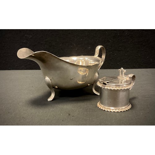 324 - A silver sauce boat, Sheffield 1959; Victorian drum mustard pot, 1886, 157.2g in total (2)