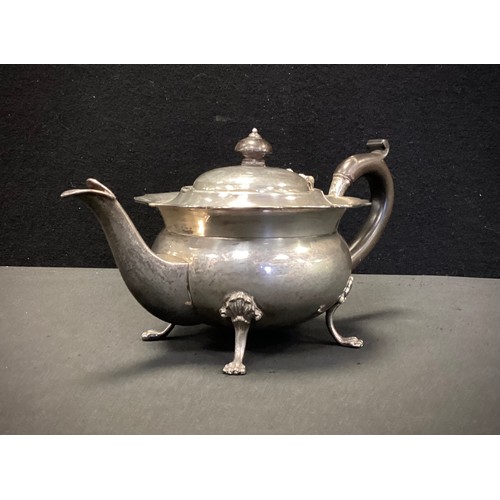 329 - A George V silver teapot, pie crust rim, ovoid body, paw feet, ebony handle, marks worn probably Fra... 