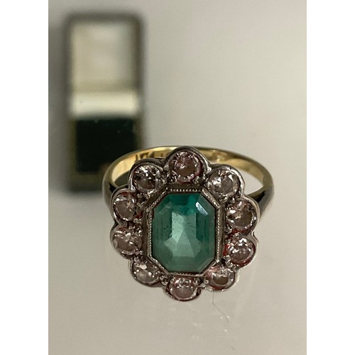 296 - An emerald and diamond cluster ring, central step cut mid tone emerald, approx 9mm x 7mm x 5mm, esti... 