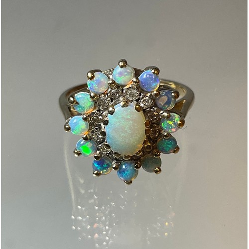 297 - An opal and diamond cluster ring, central oval opal cabochon within two collars of twelve round bril... 