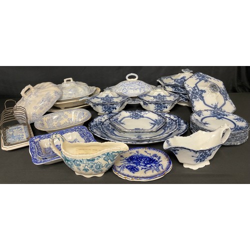 104 - A Staffordshire Adams and Co. Tedworth pattern flow blue part dinner service, including sauce tureen... 