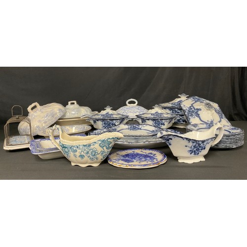 104 - A Staffordshire Adams and Co. Tedworth pattern flow blue part dinner service, including sauce tureen... 