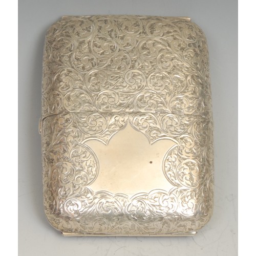 72 - An Edwardian silver rounded rectangular twin-cover cigar case, profusely engraved with scrolling fol... 