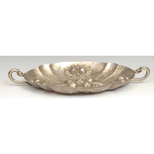 76 - A Continental silver fluted oval fruit dish, in the 17th century taste, grotesque mask handles, 39cm... 