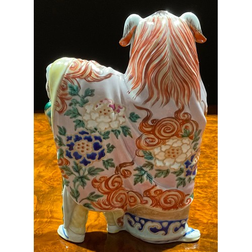 88 - A Japanese porcelain figure, as a pair of dancers in Chinese temple lion costume, the rear dancer pe... 