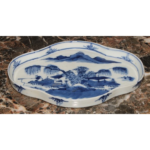 94 - A Chinese quatrefoil dish, painted in tones of underglaze blue, with a fisherman in a landscape, 19c... 