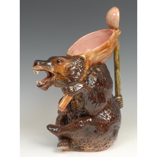 153 - A Victorian majolica novelty syrup jug, by Joseph Holdcroft, as a seated bear holding a spoon, impre... 