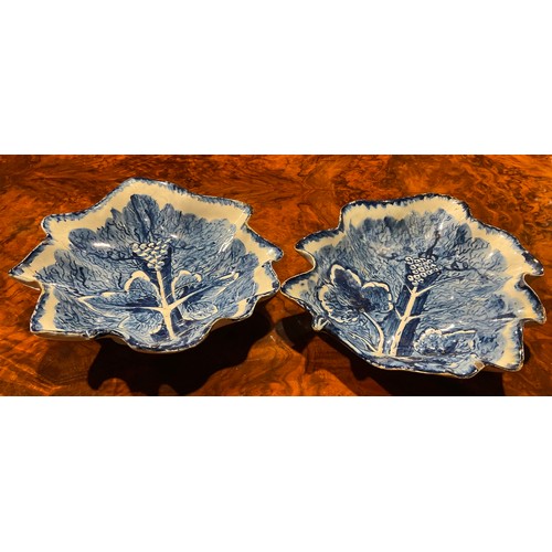 164 - A near pair of large Bow leaf shaped dishes, painted in dark blue with grape and vine, the largest 2... 