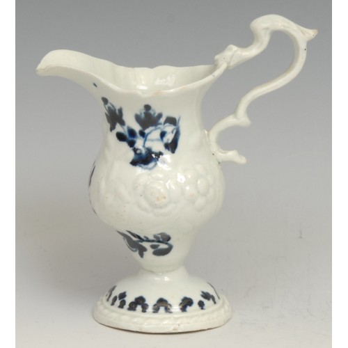 168 - A Liverpool pedestal cream jug, moulded with flowers, decorated in underglaze blue with floral sprig... 