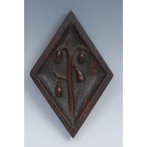 203 - A 19th century oak lozenge shaped panel, carved in relief with a Classical urn, 22cm x 12cm; another... 