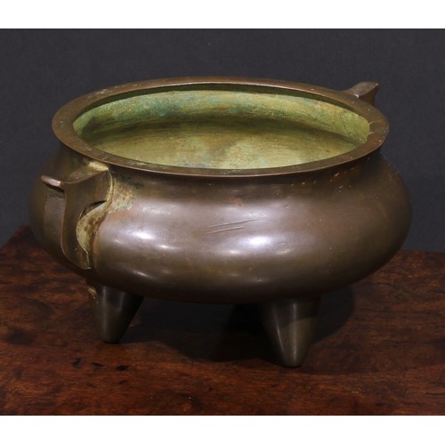 220 - A Chinese bronze tripod ding censer, scroll handles, 22cm wide, 19th century