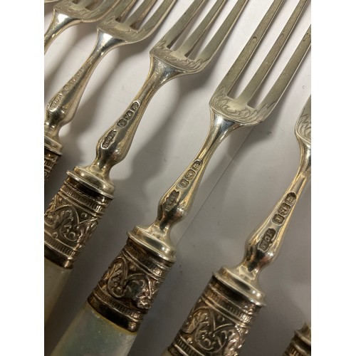 324 - A set of Edwardian silver tea knives and forks, to serve twelve, the silver blades chased and engrav... 