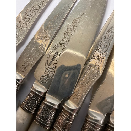 324 - A set of Edwardian silver tea knives and forks, to serve twelve, the silver blades chased and engrav... 